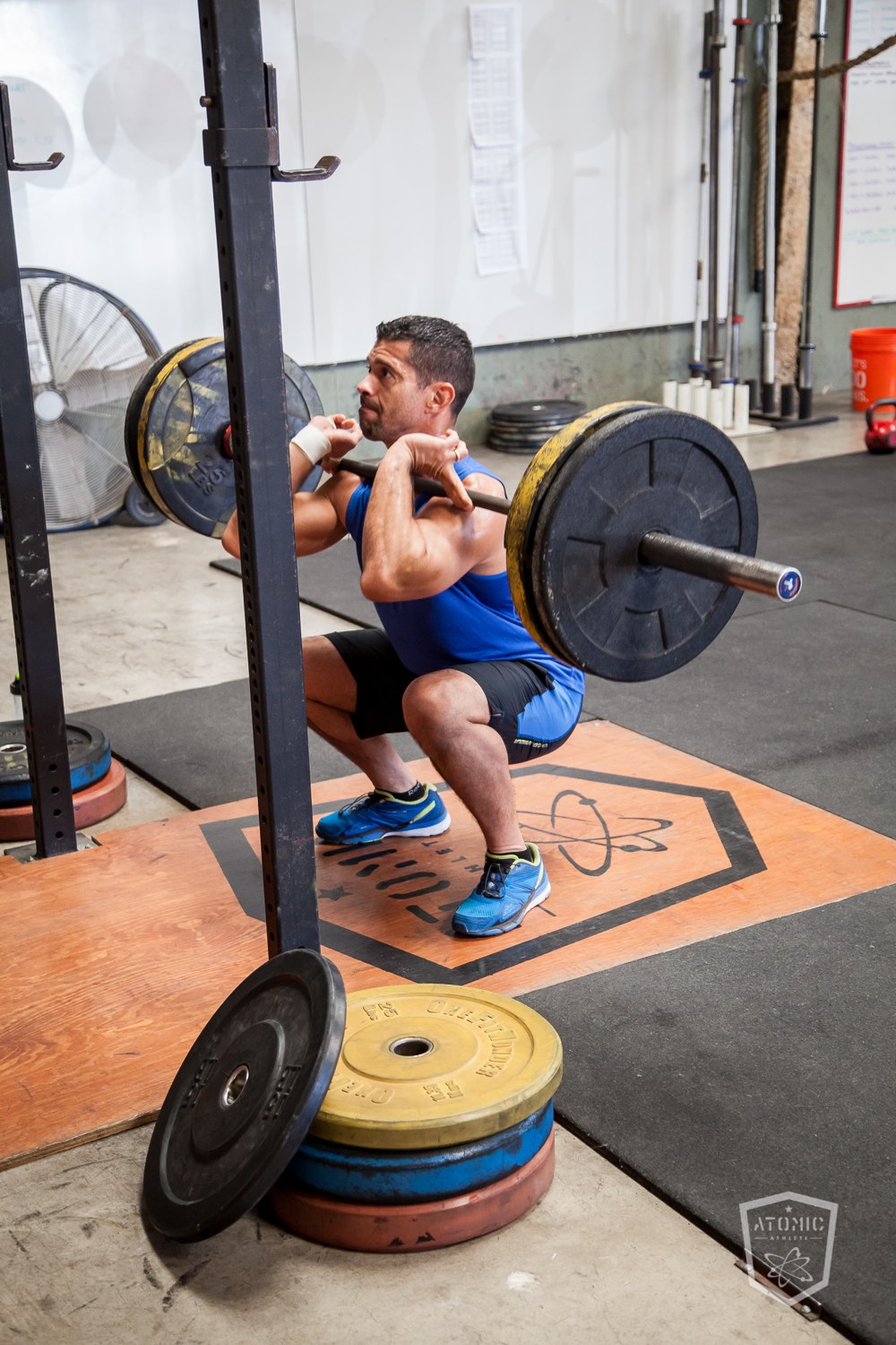 An athlete deep in a heavy front squat, building strength on a schedule that fits around rolling