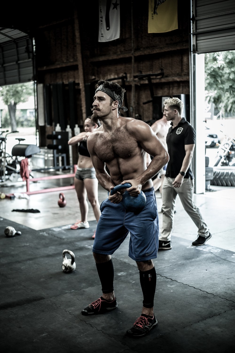 A lean, hard-trained athlete set in a gritty gym, the kind of strength base that holds up under a live opponent